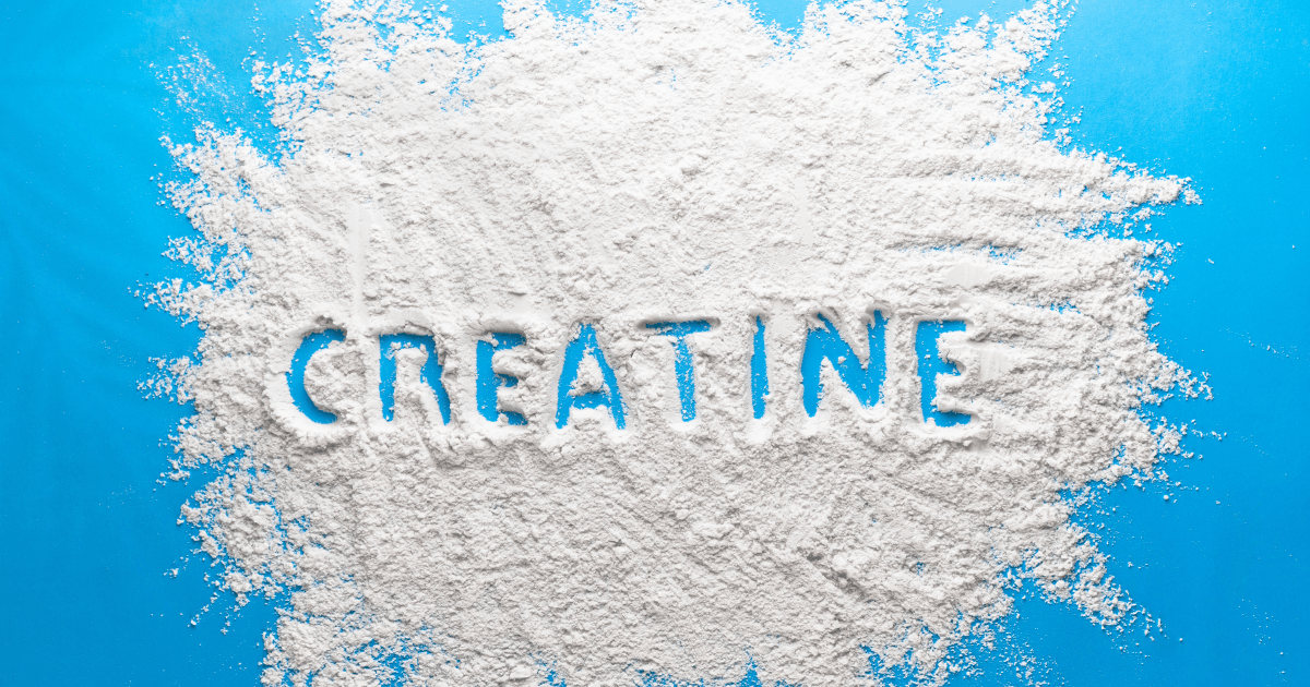 The term "creatine" formed from white powder on a blue backdrop, showcasing the product's essence and visual appeal.