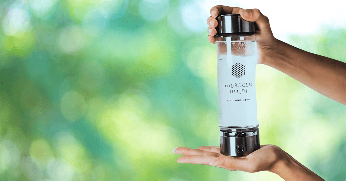 A person holding a branded water bottle, showcasing the logo prominently against a neutral background.
