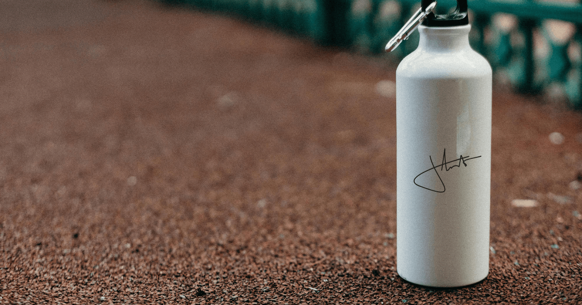 A white water bottle featuring a sturdy black handle for easy carrying and convenience.
