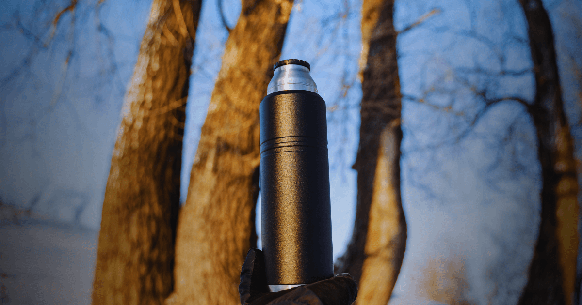 A sleek black and silver bottle, elegantly designed, showcasing a modern aesthetic suitable for various beverages.