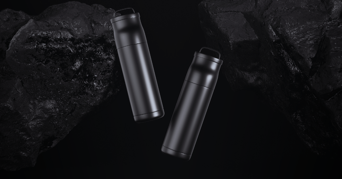 Two black and white electric cigarettes resting on a rock surface, showcasing their sleek design against a natural backdrop.