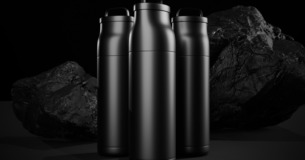 Three black water bottles arranged atop a rugged rock surface, showcasing a natural outdoor setting.