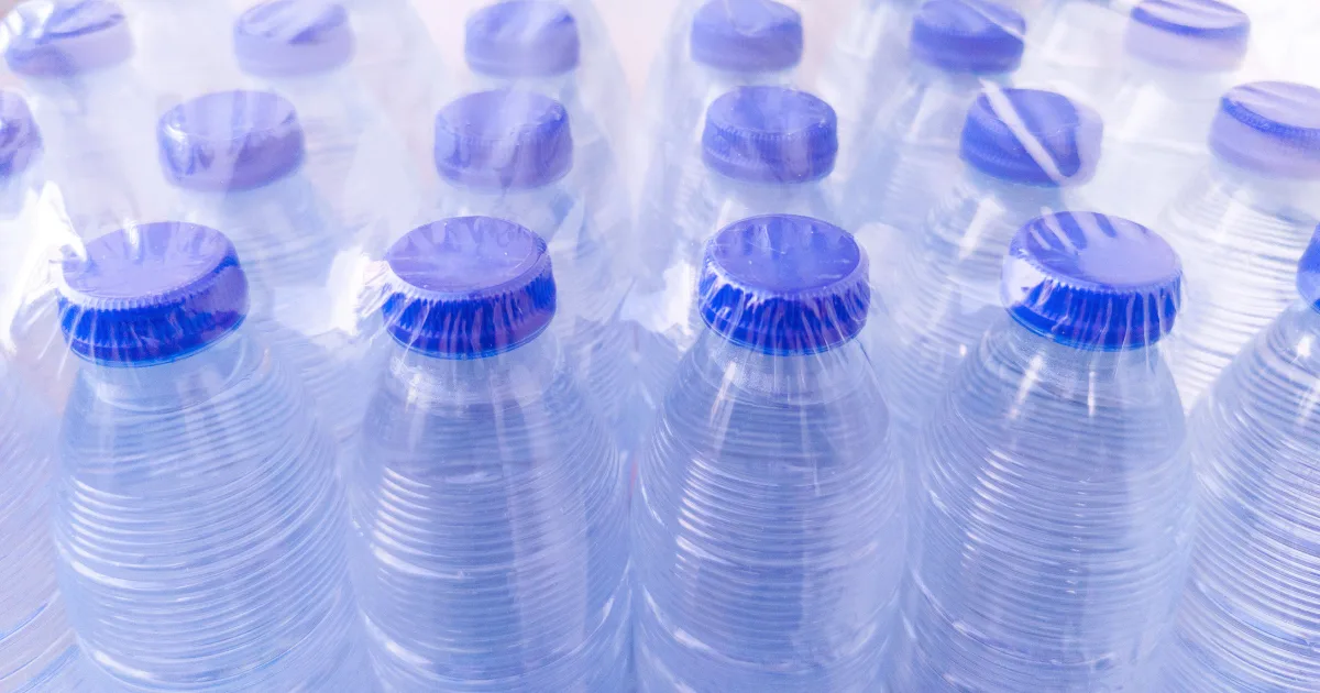 A close-up view of numerous plastic bottles stacked together, showcasing their varied shapes and colors.