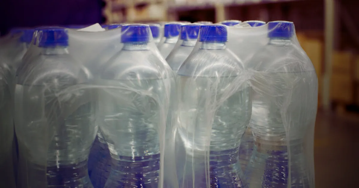 A collection of plastic bottles arranged neatly on a shelf, showcasing various shapes and sizes.