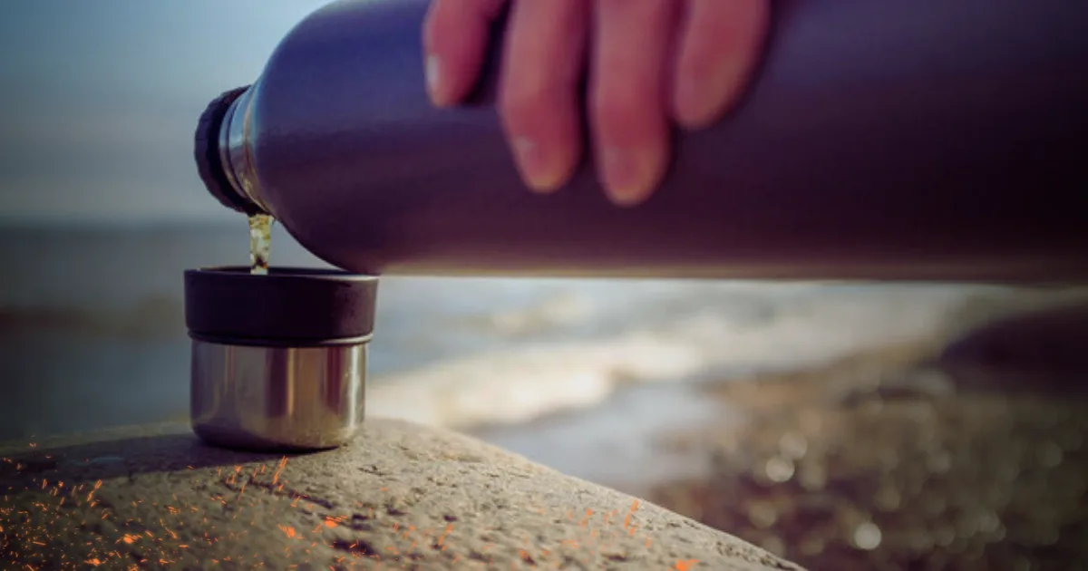 A person adds water to an Owala stainless steel bottle, promoting healthy hydration and environmental consciousness.
